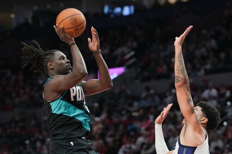 Jrue Holiday, izquierda, de los Trail Blazers de Portland, dispara a la canasta en la segunda mitad del juego de baloncesto de la NBA contra los Kings de Sacramento, el domingo 12 de abril de 2026, en Portland, Oregon. (AP Foto/Jenny Kane)