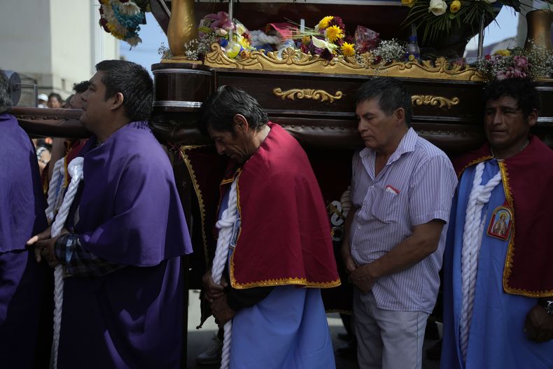 Pescadores cargan la imagen de San Pedro como parte de una procesión por tierra y mar en honor del santo patrón católico de los pescadores en la celebración del día de los pescadores en Pucusana, Perú, el jueves 29 de junio de 2023. (AP Foto/Martín Mejía)