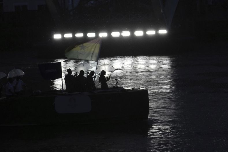 Miembros del equipo de Ghana navegan en un barco por el río Sena durante la ceremonia de apertura de los Juegos Olímpicos de 2024, el viernes 26 de julio de 2024 en París, Francia. (AP Foto/Tsvangirayi Mukwazhi)