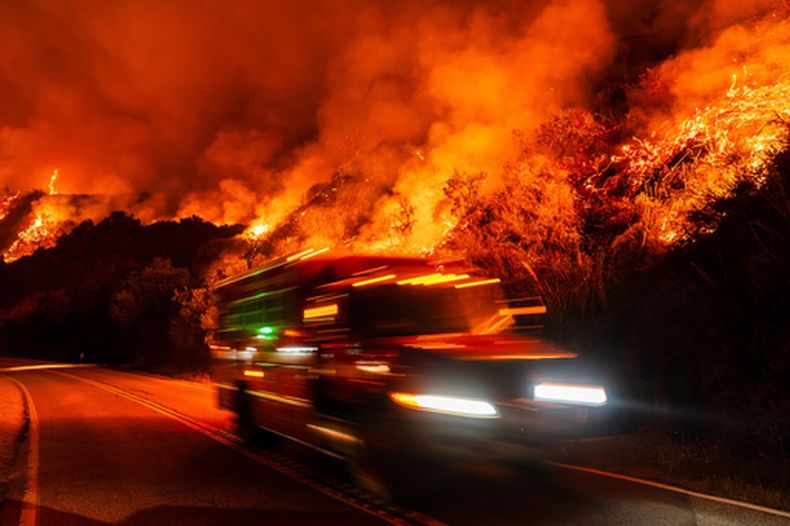 Un camión de bomberos circula por una carretera mientras el incendio Plaskett avanza hacia la Autopista 1, el 28 de agosto de 2026, en Big Sur, California. (AP Foto/Ethan Swope)