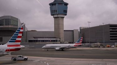 Un avión de American Eagle pasa delante de la torre de control de tráfico aéreo de la Administración Federal de Aviación en el aeropuerto LaGuardia, el domingo 9 de noviembre de 2025, en Queens, Nueva York. (AP Foto/Adam Gray)