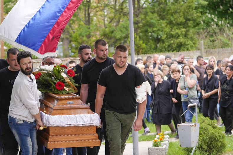 Familiares de una víctima cargan el sábado 6 de mayo de 2023 el ataúd durante el funeral para cinco personas que murieron al ser baleadas en el segundo tiroteo que se registra en Belgrado, Serbia, en dos días. (AP Foto/Darko Vojinovic)