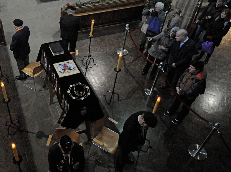 ARCHIVO - Miembros del público observan el ataúd de Ricardo III mientras reposa dentro de la Catedral de Leicester, Leicester, Inglaterra el lunes 23 de marzo de 2015. (Foto AP/Rui Vieira, archivo)