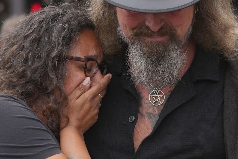 Fan reaccionan después de depositar flores para conmemorar la muerte de Ozzy Osbourne en el puente Black Sabbath en Birmingham, el miércoles 23 de julio de 2025. (Foto AP/Kin Cheung)