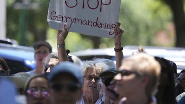 Una mujer sostiene una pancarta durante una protesta contra la audiencias de redistribución de mapas electorales en el Capitolio de Texas, el jueves 24 de julio de 2025, en Austin, Texas. (AP Foto/Eric Gay)