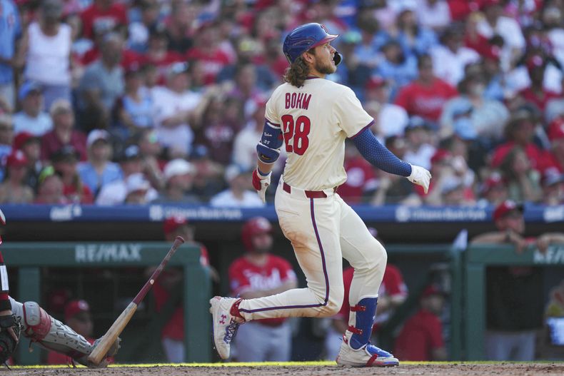 Alec Bohm, de los Filis de Filadelfia, observa su jonrón de dos carreras ante el lanzador de los Rojos de Cincinnati, Nick Lodolo, durante la sexta entrada de un partido de béisbol, el sábado 5 de julio de 2025, en Filadelfia. (AP Photo/Derik Hamilton)