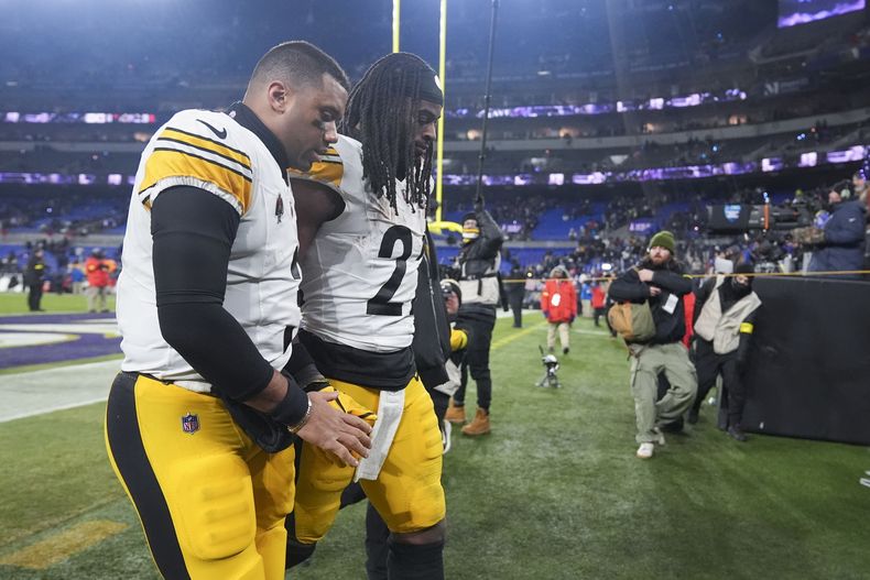 El quarterback de los Steelers de Pittsburgh Russell Wilson sale del campo con el corredor Najee Harris tras la derrota en el juego de comodín ante los Ravens de Baltimore el sábado 11 de enero del 2025. (AP Foto/Stephanie Scarbrough)