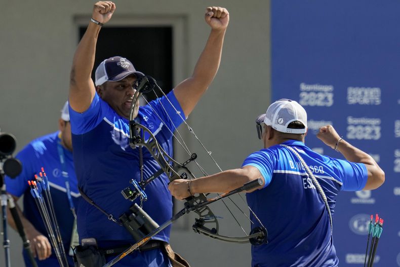 Los salvadoreños Roberto Hernández, izquierda, y Douglas Nolasco celebran luego de ganar la medalla de oro en el tiro con arco compuesto por equipos en los Juegos Panamericanos en Santiago, Chile, el sábado 4 de noviembre de 2023. (AP Foto/Esteban Félix)