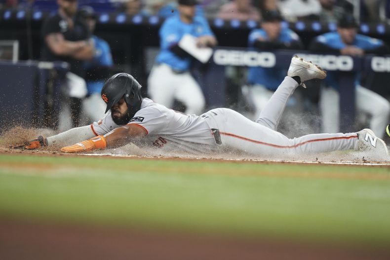 Heliot Ramos, de los Gigantes de San Francisco, anota gracias a un rodado conectado por Wilmer Flores durante la tercera entrada contra los Marlins de Miami, el domingo 1 de junio de 2025, en Miami. (Foto AP/Lynne Sladky)