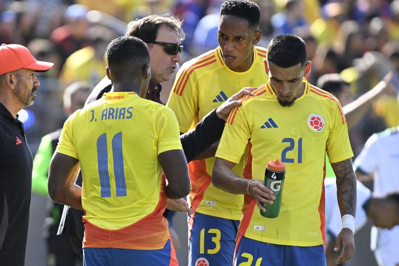 El técnico de Colombia Néstor Lorenzo charla con los jugadores Jhon Arias (11), Yerry Mina (13) y Daniel Muñoz (21) durante el amistoso contra Bolivia, el sábado 15 de junio de 2024, en East Hartford, Connecticut. (AP Foto/Jessica Hill)