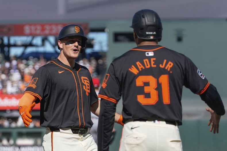 Matt Chapman festeja con Lamonte Wade, su compañero en los Gigantes de San Francisco, tras conectar un grand slam frente a los Rojos de Cincinnati durante el primer inning del juego del sábado 11 de mayo de 2024 (AP Foto/Godofredo A. Vásquez)