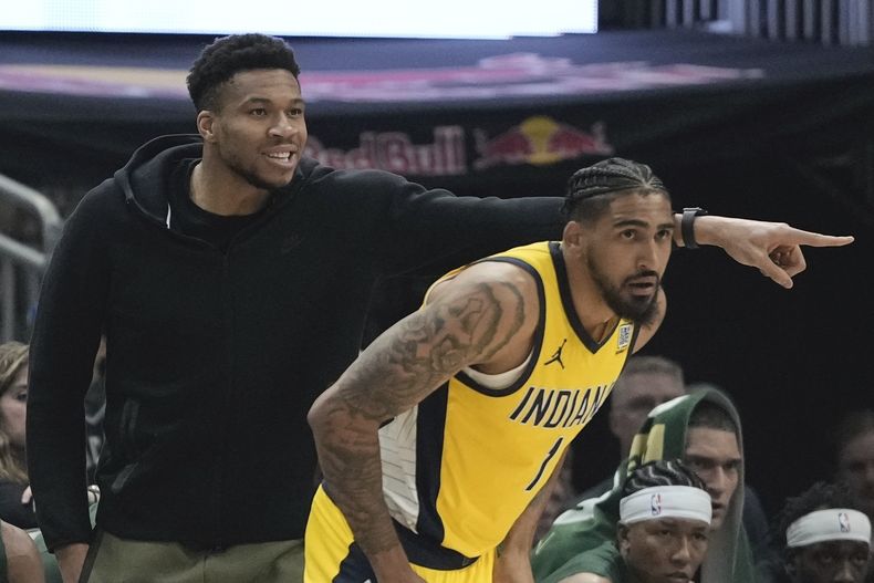 Giannis Antetokounmpo, de los Bucks de Milwaukee, reacciona desde la banca detrás de Obi Toppin, de los Pacers de Indiana durante el Juego 1 de la serie de playoffs del baloncesto de la NBA, el domingo 21 de abril de 2024, en Milwaukee. (AP Foto/Morry Gash)