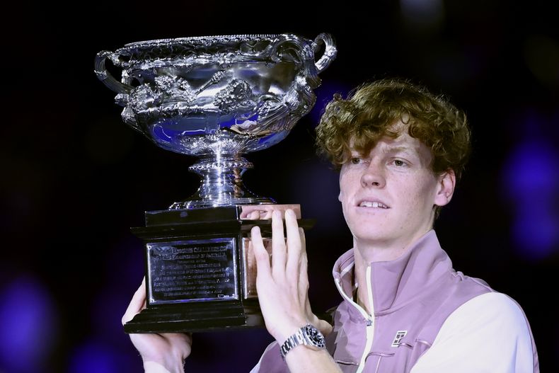 ARCHIVO - Foto del 28 de enero del 2024, el italiano Jannik Sinner sostiene el trofeo tras ganar el Abierto de Australia al superar a Daniil Medvedev en la final. El viernes 14 de junio del 2024, la Federación de Tenis de Italia confirma que Sinner participará en el torneo individual y de dobles olímpico. (AP Foto/Asanka Brendon Ratnayake, Archivo)
