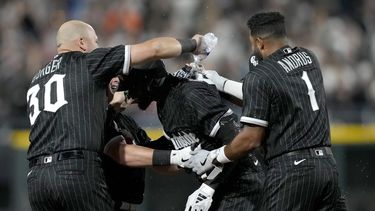 El cubano Luis Robert Jr., de los Medias Blancas de Chicago es felicitado por sus compañeros tras empujar la carrera del triunfo ante los Marlins de Miami, el viernes 9 de junio de 2023 (AP Foto/Charles Rex Arbogast)