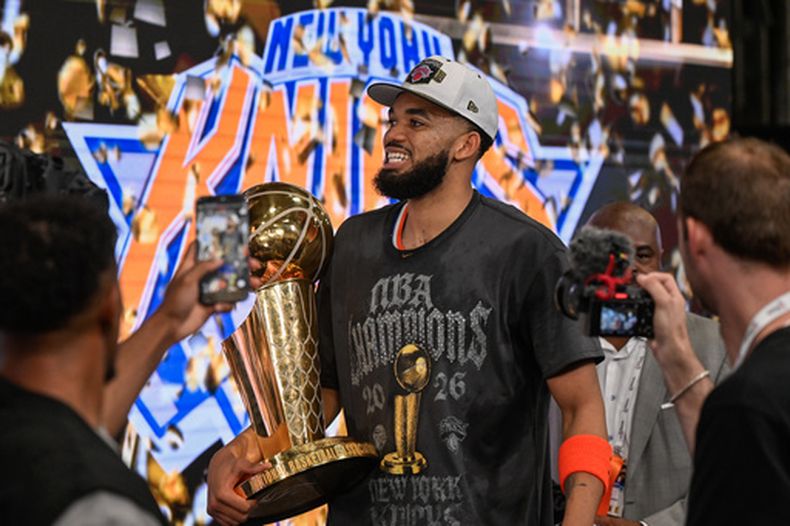 ARCHIVO - Karl-Anthony Towns, de los Knicks de Nueva York, carga el trofeo Larry OBrien tras el campeonato de los Knicks al superar en las Finales de la NBA a los Spurs de San Antonio, el 13 de junio de 2026, en San Antonio. (AP Foto/Darren Abate, Archivo)