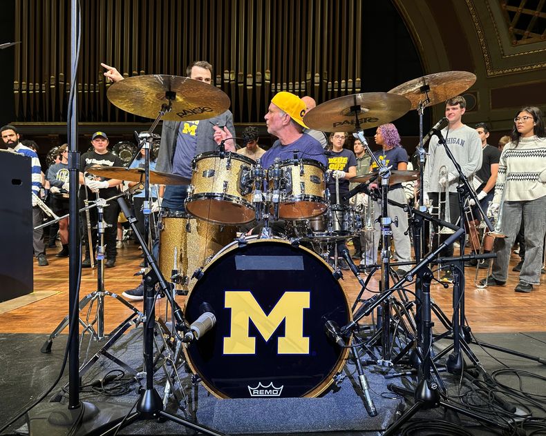 El baterista de los Red Hot Chili Peppers, Chad Smith, actúa con la Banda de Marcha de Michigan en el Auditorio Hill del campus de la Universidad de Michigan el domingo 2 de noviembre de 2025, en Ann Arbor, Michigan. (Foto AP/Mike Householder)