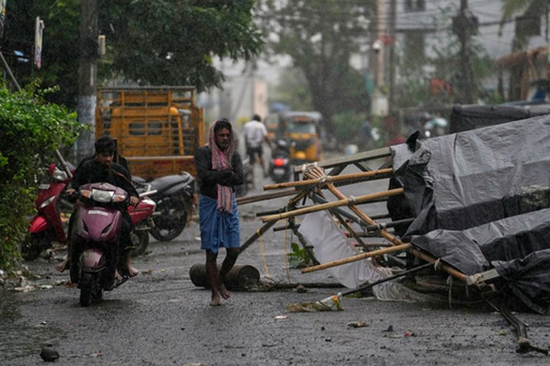 Un hombre pasa junto a destrozos causados por el ciclón Arnab a su paso por Kakinada, India, el 28 de octubre de 2026. (AP Foto/Mahesh Kumar A.)