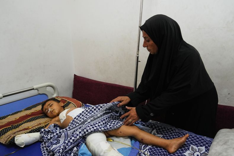 Hanan Shakshk cuida a su nieto Yahya Shorbasi, quien resultó herido por la detonación de una bomba junto con su hermana gemela Nabila, de seis años, en el Hospital Shifa de Ciudad de Gaza, el sábado 25 de octubre de 2025. (Foto AP/Abdel Kareem Hana)