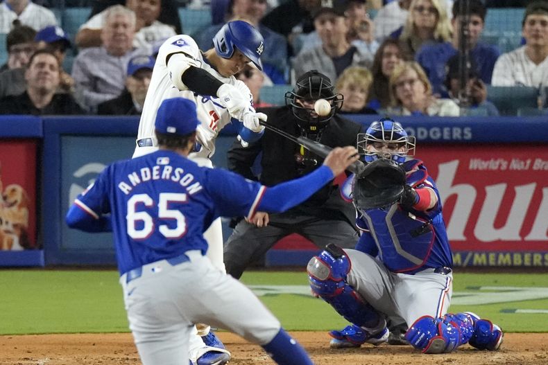 El japonés Shohei Ohtani, de los Dodgers de Los Ángeles, batea un jonrón de dos carreras en el duelo ante los Rangers de Texas, el martes 11 de junio de 2024 (AP Foto/Mark J. Terrill)