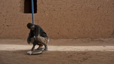 ARCHIVO – Un joven migrante expulsado de Argelia se sienta en un centro de tránsito en Arlit, Níger, el viernes 1 de junio de 2018. (AP Foto/Jerome Delay, Archivo)