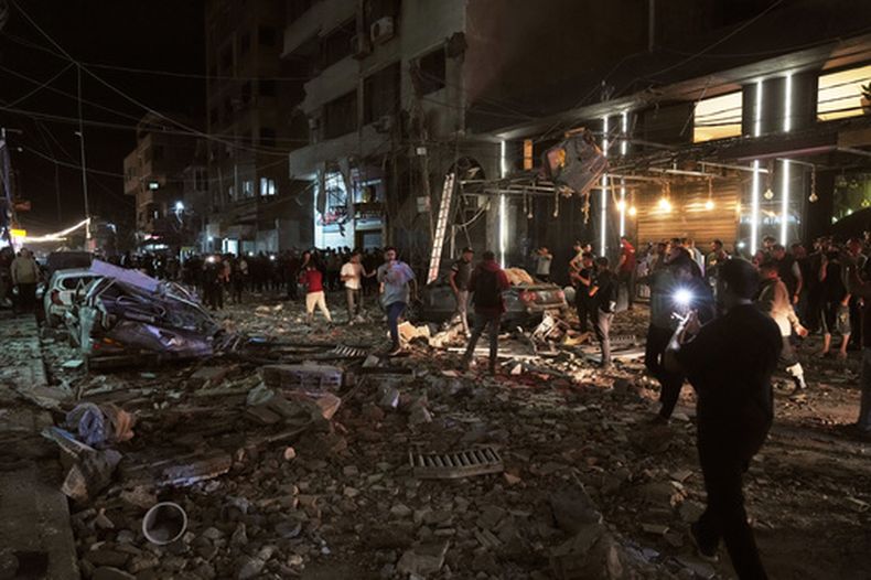 Unos palestinos inspeccionan el lugar donde se produjo un ataque aéreo israelí en Ciudad de Gaza el martes 26 de mayo de 2026. (AP Foto/Jehad Alshrafi)