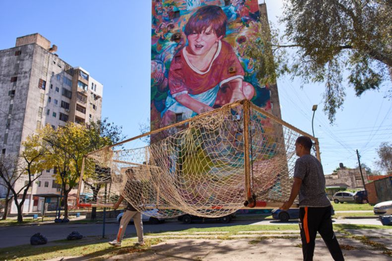 Empleados del club de fútbol Grandoli cargan un arco en la cancha para un partido de fútbol infantil en Rosario, Argentina, el sábado 2 de mayo de 2026. (AP Foto/Rodrigo Abd)