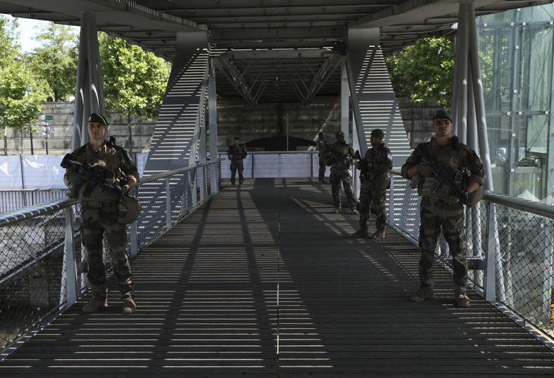 Soldados hacen un recorrido a pie sobre un puente que pasa por encima del Río Sena el miércoles 17 de julio del 2024. (AP Foto/Aurelien Morissard)