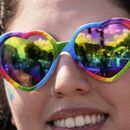 Una persona con gafas en forma de corazón y con los colores del arcoíris mira el desfile del Orgullo Mundial LGBTQ+ el sábado 7 de junio de 2025, en Washington. (AP Foto/Alex Brandon)