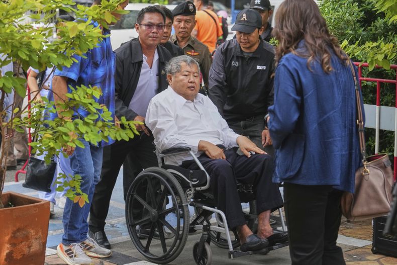Premchai Karnasuta, presidente de la constructora italo-tailandesa Development Co, llega en silla de ruedas a la comisaría de Bang Sue, en Bangkok, Tailandia, el 16 de mayo de 2025, para entregarse a la policía por la acusación de negligencia presentada en su contra tras el derrumbe de un rascacielos en Bangkok durante el sismo del 28 de marzo. (AP Foto/Sakchai Lalit)