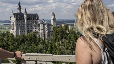 Personas observan el castillo de Neuschwanstein, en Schwangau, Alemania, el jueves 15 de junio de 2023. (Frank Rumpenhorst/dpa vía AP)