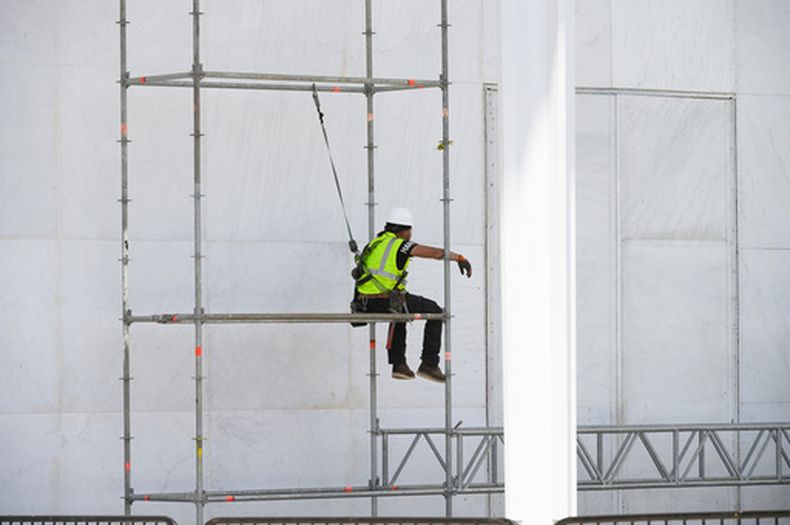 Un trabajador se sienta en un andamio en el John F. Kennedy Center for the Performing Arts en Washington, el viernes 12 de junio de 2026. (AP Foto/Cliff Owen)