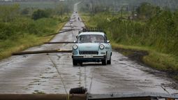 La gente conduce por una carretera llena de cables eléctricos caídos tras el paso del huracán Rafael en San Antonio de los Baños, Cuba, el jueves 7 de noviembre de 2024. (Foto AP/Ramón Espinosa)