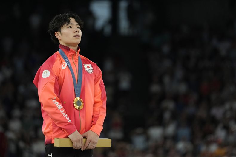 El japonés Shinnosuke Oka parado en el podio tras recibir su medalla de oro tras ganar el All-Around de la gimnasia masculina en la Arena Bercy en los Juegos Olímpicos de París el miércoles 31 de julio del 2024. (AP Foto/Abbie Parr)
