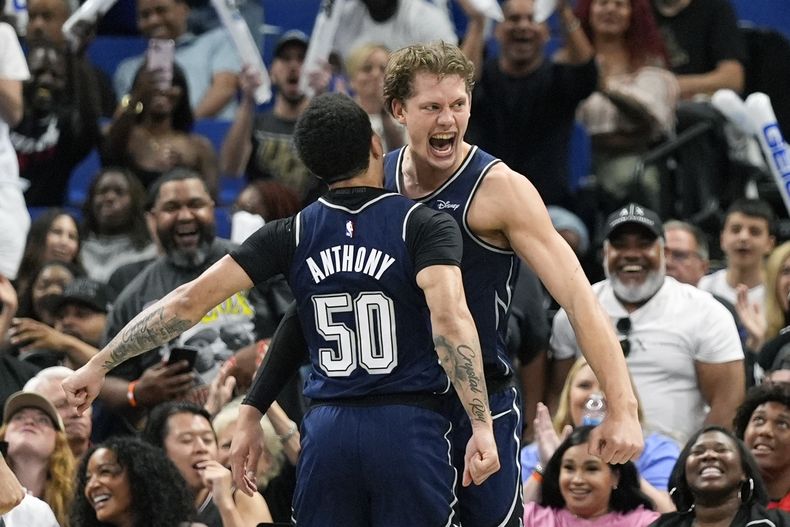 Moritz Wagner, derecha, del Magic de Orlando, celebra con Cole Anthony (50) después de clavar el balón en contra de los Bulls de Chicago y recibir una falta en contra de los Bulls de Chicago, durante la segunda mitad del juego de baloncesto de la NBA, el domingo 7 de abril de 2024, en Orlando, Florida (AP Foto/John Raoux)