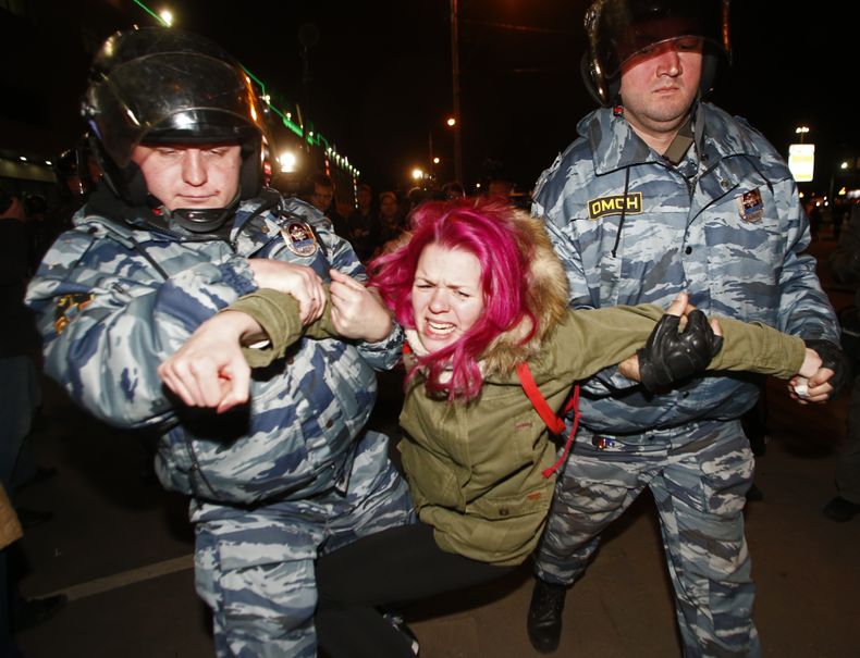 Polic&iacute;as detienen a una manifestante en Mosc&uacute;, Rusia, el martes 15 de octubre de 2013. (AP Foto/Denis Tyrin)