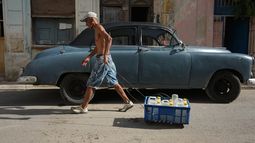 Un hombre tira de un carrito que transporta agua potable durante un apagón en La Habana, Cuba, el lunes 3 de agosto de 2026. (AP Foto/Ramón Espinosa)