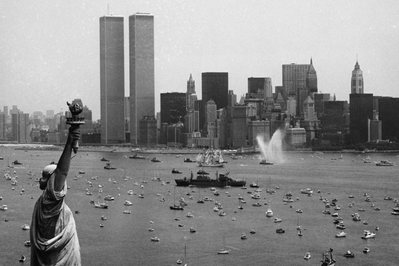 ARCHIVO - Diversas embarcaciones participan en la Operación Vela entre la Estatua de la Libertad y el World Trade Center para celebrar el bicentenario de Estados Unidos, el 4 de julio de 1976, en Nueva York. (AP Foto/Eddie Adams, archivo)