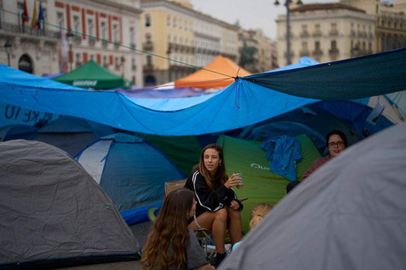 Manifestantes acampan durante una protesta en la plaza de la Puerta del Sol tras el desahucio el miércoles anterior de una mujer de 87 años, conocida popularmente como Maricarmen, para pedir leyes más fuertes para proteger a los inquilinos en Madrid, España, el lunes 28 de septiembre de 2026. (AP Foto/Manu Fernández)