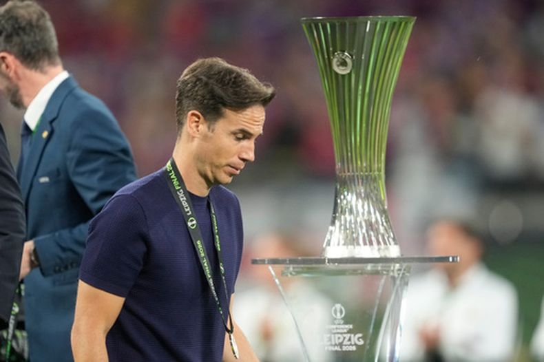 El técnico del Rayo Vallecano Inigo Perez pasa junto al trofeo de la Conference League tras perder la final con el Crystal Palace el miércoles 27 de mayo del 2026. (AP Foto/Michael Probst)