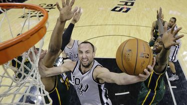 americateve | El argentino Manu Gin&oacute;bili, de los Spurs de San Antonio, dispara delante de Derrick Favors, del Jazz de Utah, en el encuentro del domingo 16 de marzo de 2014 (AP Foto/Eric Gay)