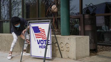 ARCHIVO- La trabajadora electoral Pranee Sheskey coloca un cartel fuera del Warner Park Community Recreation Center para el primer día de votación anticipada el martes 21 de marzo de 2023, en Madison, Wisconsin. (AP Foto/Morry Gash, Archivo)