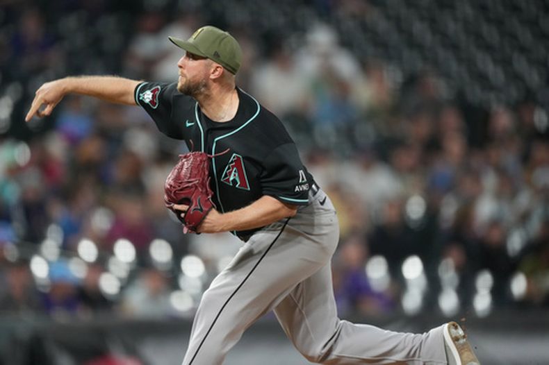 Merrill Kelly, abridor de los Diamondbacks de Arizona, labora en el juego del viernes 15 de mayo de 2026, ante los Rockies de Colorado (AP Foto/David Zalubowski)
