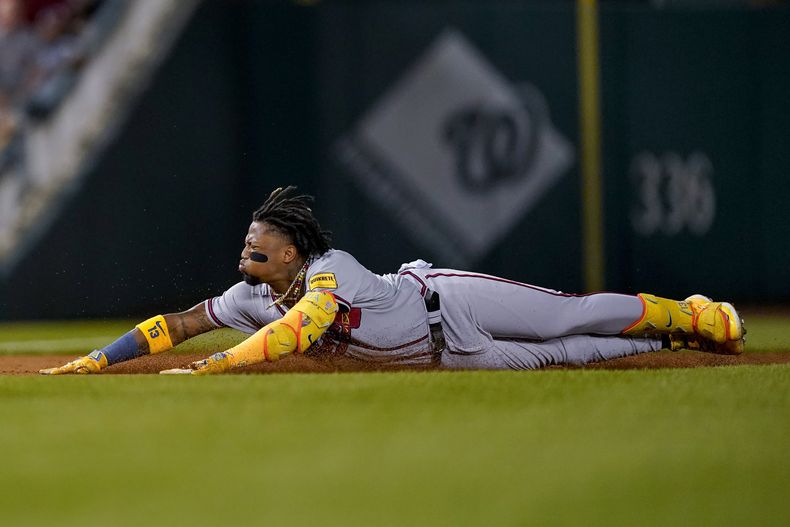El venezolano Ronald Acuña Jr. se desliza en la antesala al conectar un triple ante los Nacionales de Washington, el jueves 21 de septiembre de 2023 (AP Foto/Andrew Harnik)