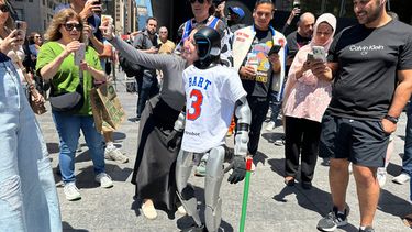 Un aficionado se toma una foto con un robot vestido con un uniforme de los Knicks de Nueva York cerca del Madison Square Garden en Nueva York el lunes 8 de junio del 2026. (AP Foto/Ted Shaffrey)