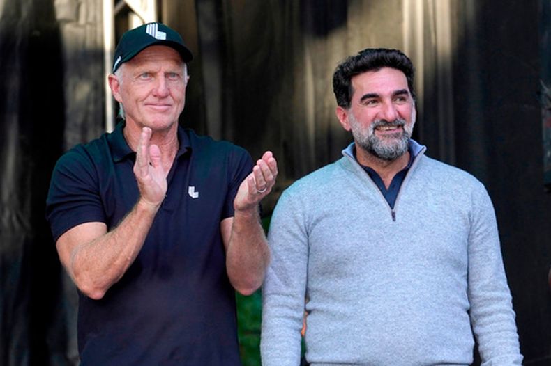 ARCHIVO - Greg Norman, director ejecutivo de LIV Golf (izquierda), aplaude a Yasir Al-Rumayyan, gobernador del Fondo de Inversión Pública de Arabia Saudi, en el torneo LIV Golf Invitational-Chicago, el 18 de septiembre de 2022, en Sugar Hill, Illinois. (Foto AP/Charles Rex Arbogast, Archivo)