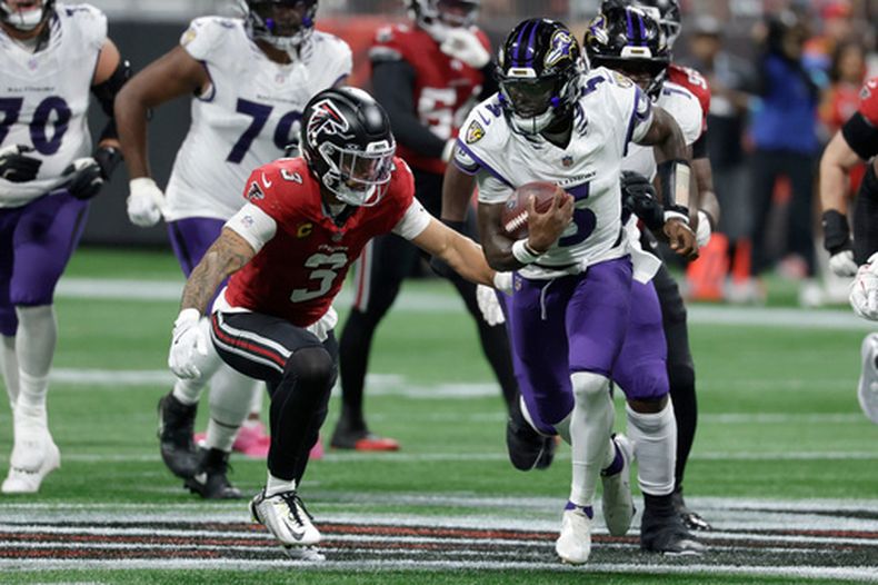 Tyler Huntley (5), quarterback de los Ravens de Baltimore, corre para escapar de Jessie Bates III (3), de los Falcons de Atlanta, durante la primera mitad del partido de la NFL, el domingo 11 de octubre de 2026, en Atlanta. (AP Foto/Erik S. Lesser)