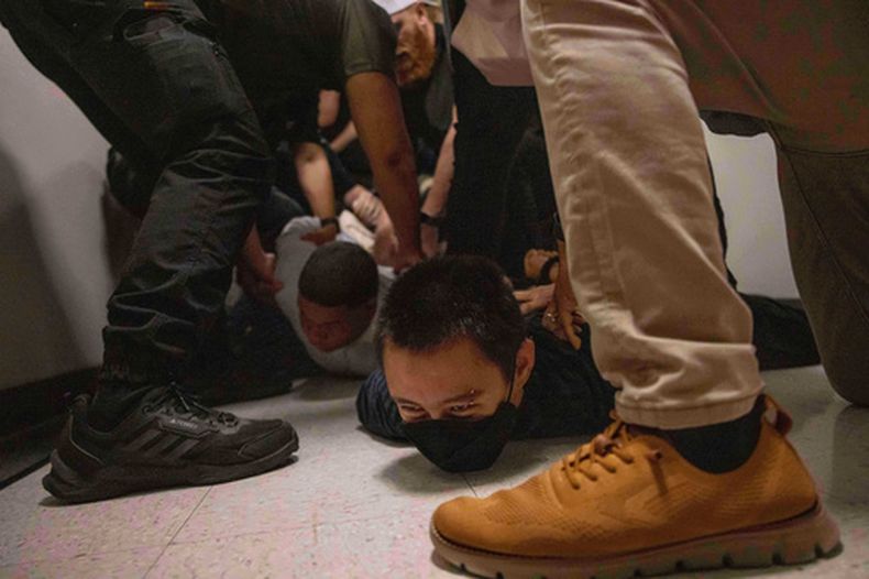 Un hombre oriundo de República Dominicana, a la izquierda, y un activista, a la derecha, son detenidos por agentes vestidos de civil del Servicio de Inmigración y Control de Aduanas después de una audiencia de inmigración en una corte migratoria, el 6 de junio de 2025, en Nueva York. (AP Foto/Yuki Iwamura, Archivo)