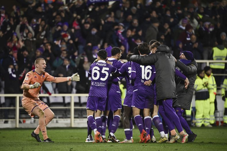Oliver Christensen, portero de la Fiorentina, se une a sus compañeros para festejar el triunfo por penales ante Bologna en la Copa Italia, el martes 9 de enero de 2024 (Massimo Paolone/LaPresse via AP)
