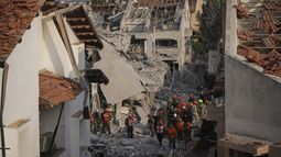 Efectivos de las fuerzas de seguridad israelíes inspeccionan un viviendas destruidas por un misil iraní, en Rishon Lezion, Israel, el 14 de junio de 2025. (AP Foto/Ohad Zwigenberg)