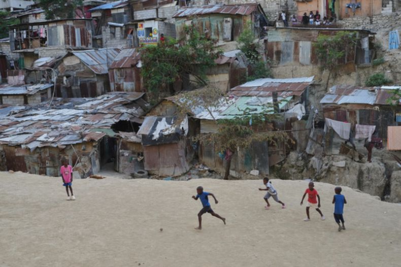 Un grupo de niños juega fútbol con una pelota de plástico en el barrio de Pétion-Ville en Puerto Príncipe, Haití, el miércoles 27 de mayo de 2026. (AP Foto/Odelyn Joseph)